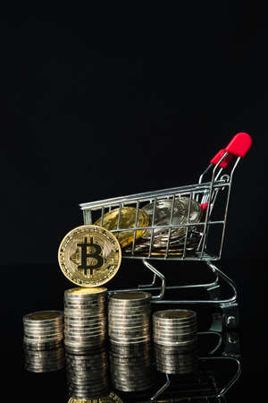 Close up Bitcoin coin in shopping cart on black backgroundの写真素材