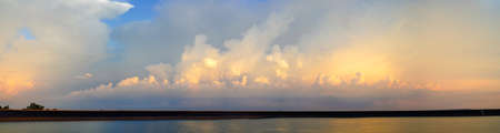 Panorama of Dramatic vibrant color with beautiful cloud of sunrise. Panoramic imageの写真素材