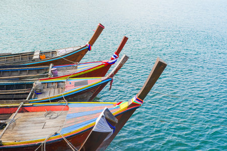 Close pu small fishing boats anchored in the sea during sunset in Thailandの写真素材