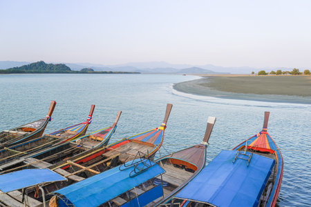 Close pu small fishing boats anchored in the sea during sunset in Thailand