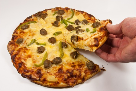 Picture of a hand grabbing a pizza sliceの写真素材