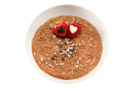 Picture of some chocolate mousse with strawberries with hearts inside themの写真素材