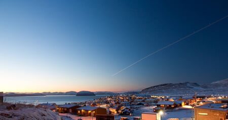 Picture of a part of the  northermost city in the world, Hammerfest  The sun is just in the horizon during day timeの写真素材