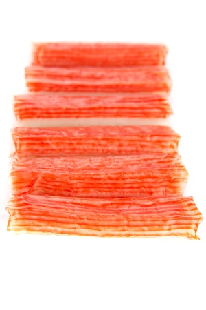 A picture of crabsticks in a row isolated on whiteの写真素材