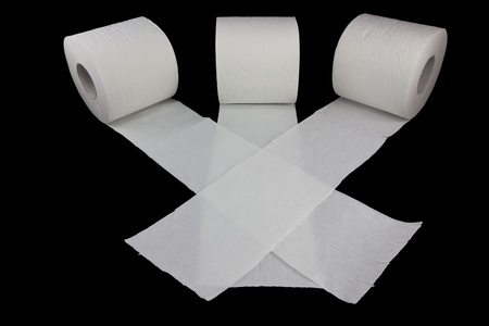 Picture of three toilet rolls racing on a black backgroundの写真素材
