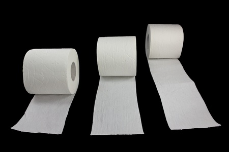 Picture of three toilet rolls racing on a black backgroundの写真素材