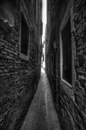 B W picture of a narrow alleyway in Veneziaの写真素材
