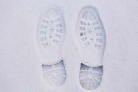 Picture of a pair of footprints in white snowの写真素材