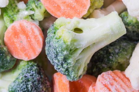 Picture of a bunch of frozen vegetables with focus on a piece of broccoliの写真素材