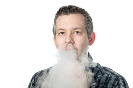 picture of a man exhaling smokeの写真素材