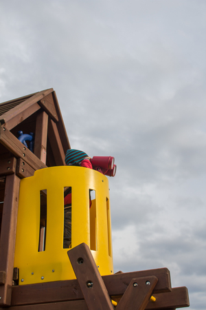 Child looking through binoculars at the playgroundの写真素材