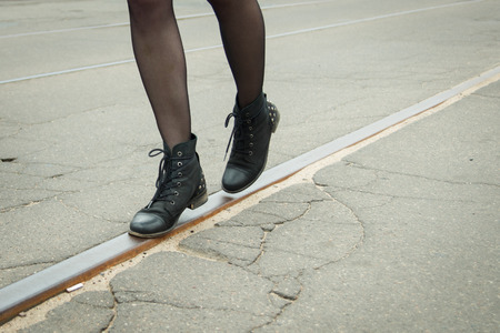Girl walking on the tracks of the tramの写真素材