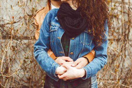 Couple hugging and holding handsの写真素材