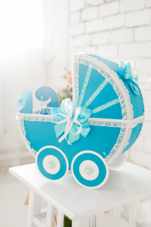 Blue baby buggy made of cardboard handmadeの写真素材