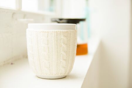 White cup standing on the windowの写真素材