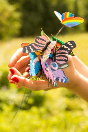 Butterflies in the hands of a girlの写真素材