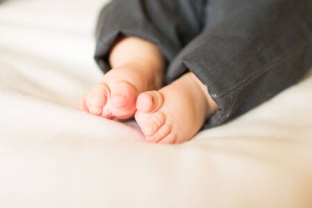Cute little baby foot on white blanket
