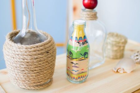 glass bottle with colored sand and the inscription Tunisia. marine decorationsの写真素材