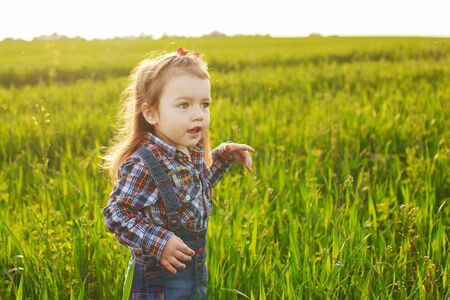little girl walking in the fieldの写真素材
