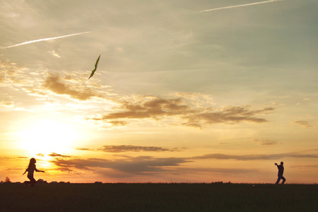 A man with a girl launches a kiteの写真素材