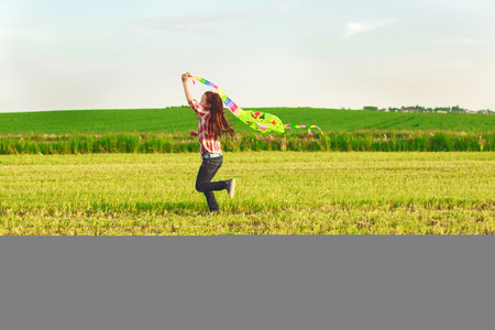 girl launches a kiteの写真素材