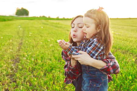 mother with her daughter in the fieldの写真素材