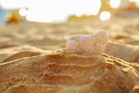 stone in the form of a heart in the sand on the beach