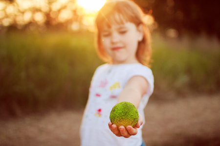 little girl with a apple in the handsの写真素材