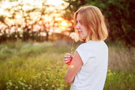 girl with a flower in the handsの写真素材