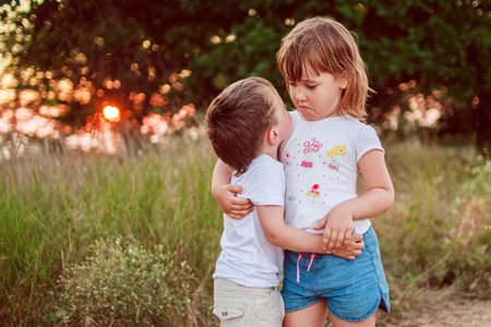 little girl and boy huggingの写真素材