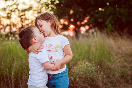 little girl and boy huggingの写真素材