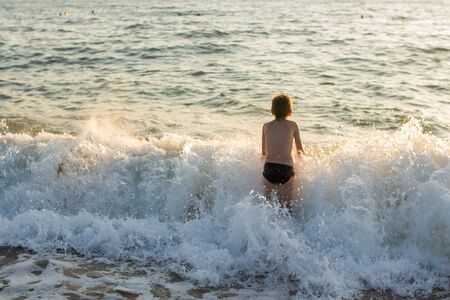 boy swimming in the sea on the wavesの写真素材