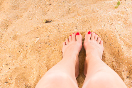 woman feet on the sand in the beachの写真素材