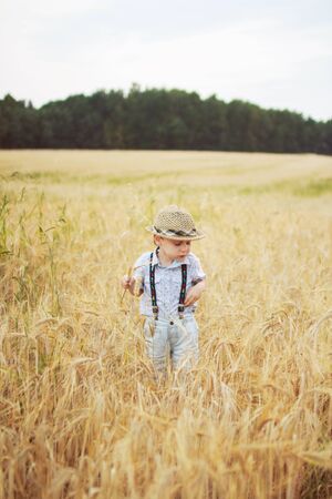 boy walking on a field of ryeの写真素材