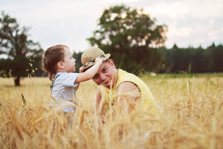 dad with son walking in a fieldの写真素材