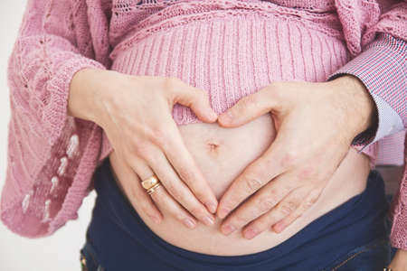 pregnant woman with a heart at the stomach