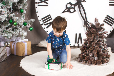 child sitting under the Christmas tree with giftsの写真素材
