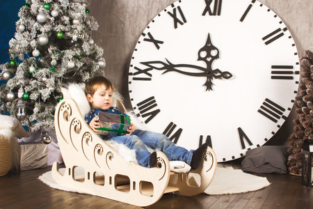 child sitting under the Christmas tree with giftsの写真素材