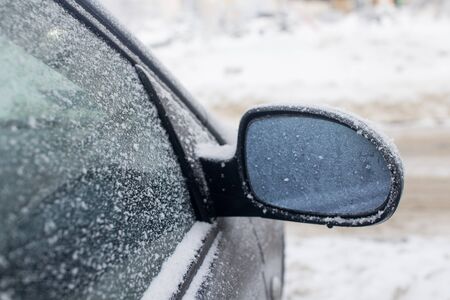 Mirror car covered with snowの写真素材