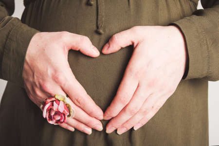 pregnant woman with a heart at the stomachの写真素材