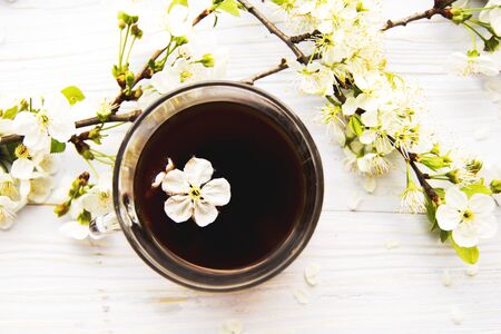 cup of coffee with spring flowersの写真素材