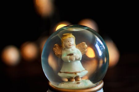 figure on the background bokeh. souvenir. Angel in a glass bowlの写真素材