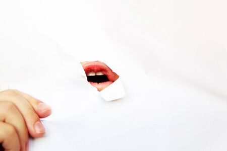 a hole in the paper with mouthの写真素材