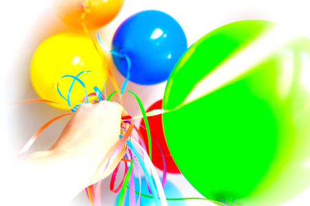 festive colored balloons in handの写真素材