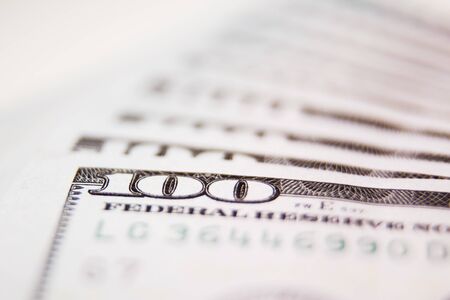 Many hundred dollar bills on white background macroの写真素材