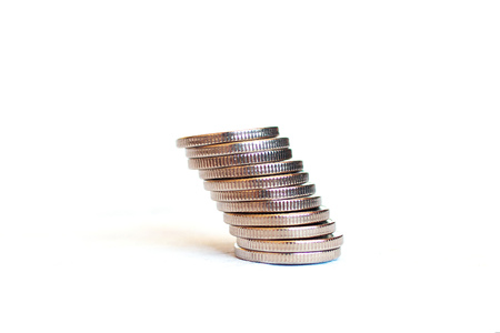 A stack of coins on an isolated white backgroundの写真素材