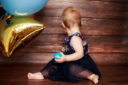 little girl with balls. first birthdayの写真素材