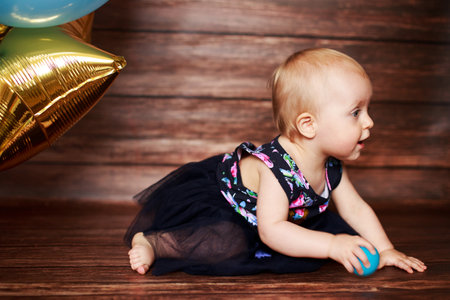 Little girl with balls. first birthdayのeditorial素材