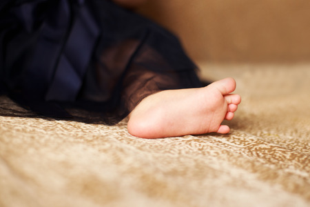 the foot of a small child on the floor