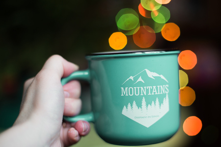 a cup in the hand . Christmas bokehの写真素材